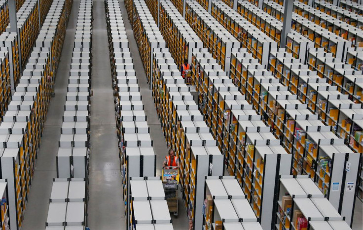 Workers collect orders at Amazon's fulfillment center in Rugeley, central England December 11, 2012. 