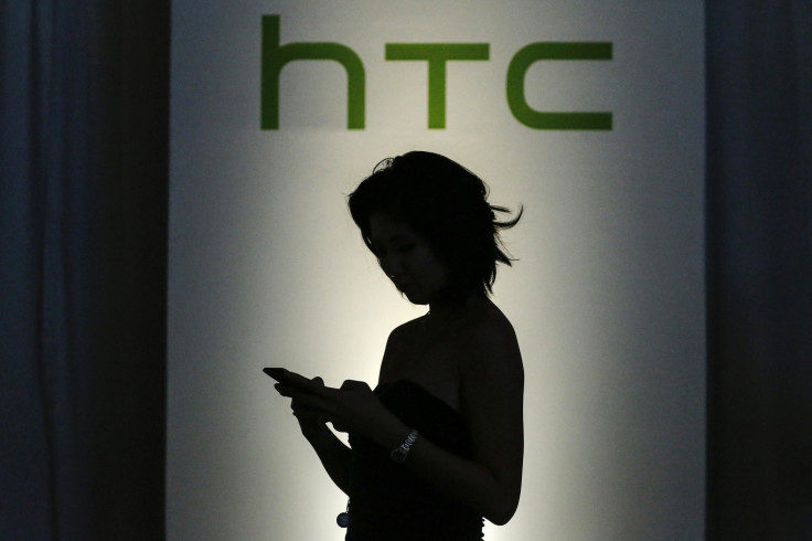 A guest checks her mobile as she arrives for the launch of new HTC products - the HTC desire eye smartphone, RE camera and RE eye experience software - in New York October 8, 2014. 