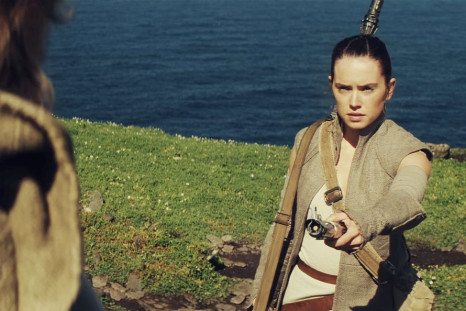 Rey hands a lightsaber to Luke Skywalker in 'Star Wars: The Force Awakens' 