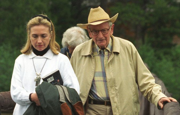 Hillary Clinton in 1995, carrying a book about extraterrestrial life.