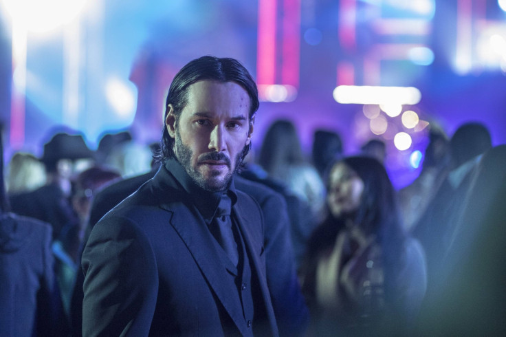 John Wick in the club, waiting for his pup to get back from the bar with his raspberry mojito.