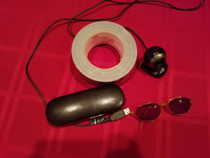 A roll of duct tape, a webcam, sunglasses and a sunglass case