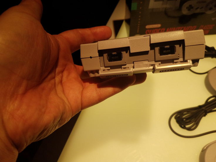 The controls slots for the Mini SNES are hidden behind a plastic covering.