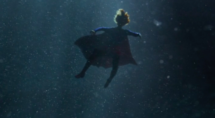 Supergirl falls into the water after she can't push back the missile. 