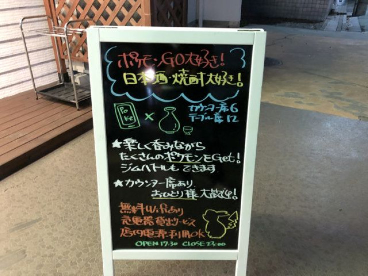 “We love Pokemon GO! We love Japanese sake/alcohol," the sign says.