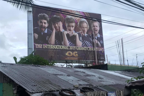 A Filipino Dota 2 fan towered a billboard with OG members' faces on it. 
