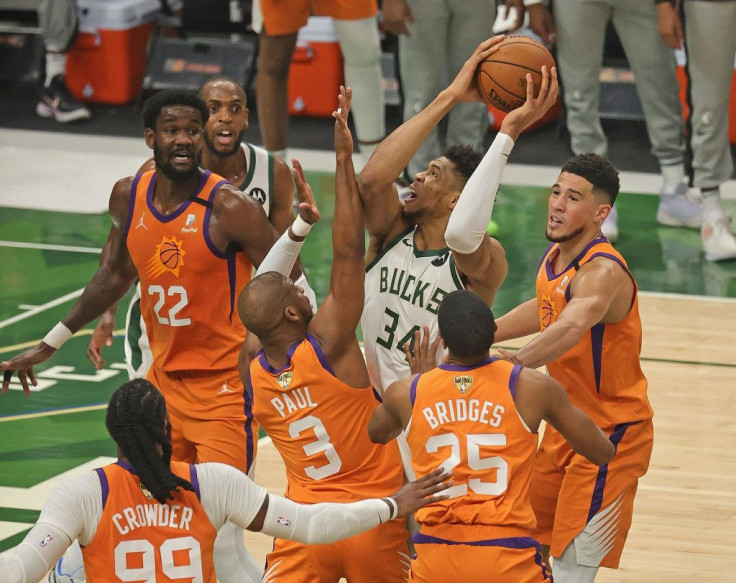 Giannis Antetokounmpo #34 of the Milwaukee Bucks tries to get off a shot under pressure from (L-R) Jae Crowder #99, Deandre Ayton #22, Chris Paul #3, Mikal Bridges #25 and Devin Booker #1 of the Phoenix Suns at Fiserv Forum on July 14, 2021 in Milwaukee, 